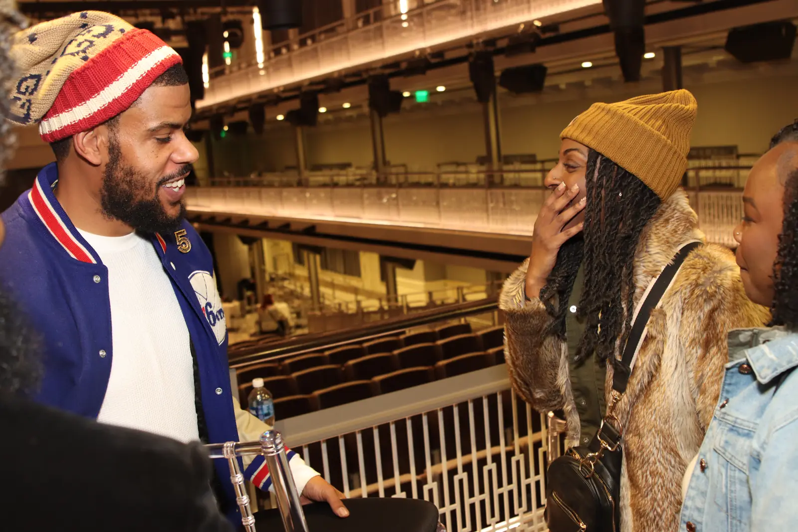 Guests talking and laughing on the balcony level of the venue
