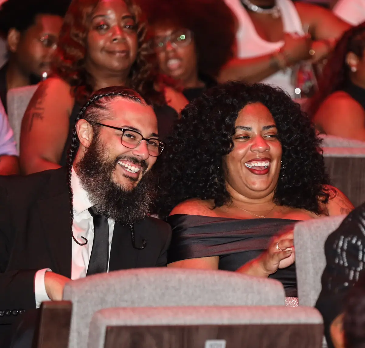 A couple laughing together in their seats during the show