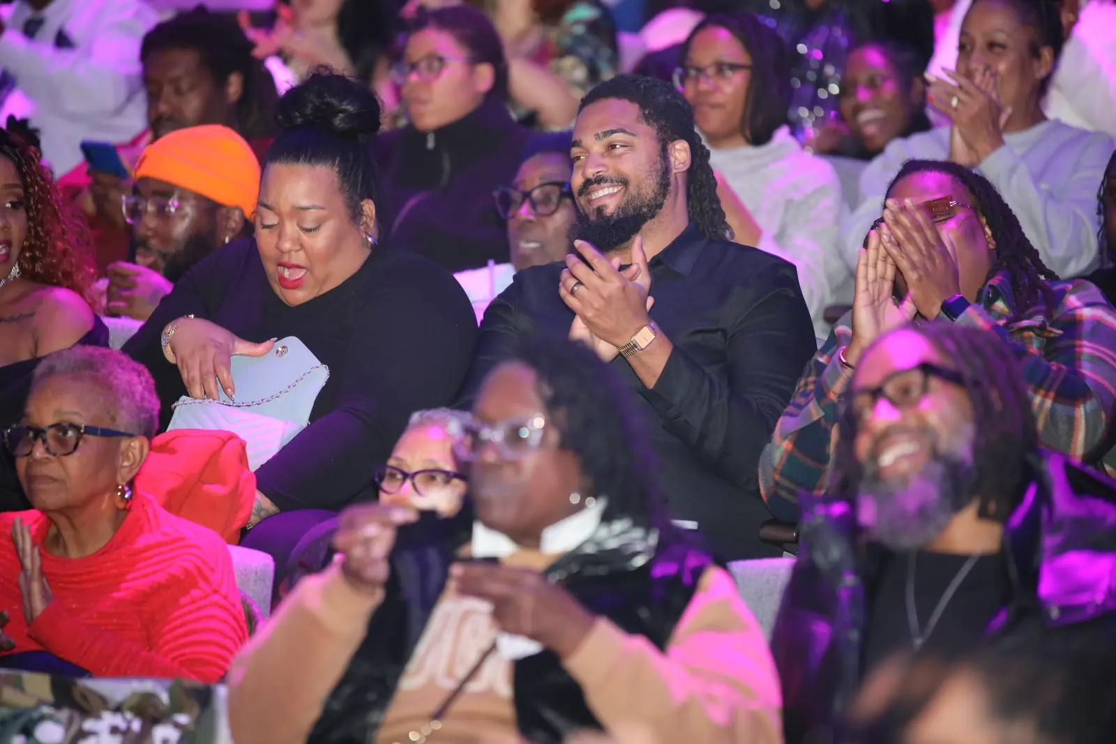 Audience members doubled over laughing in their seats