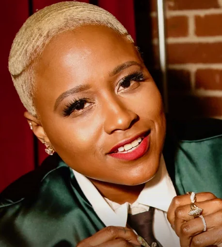Paris Sashay, smiling, in a green satin jacket and tie
