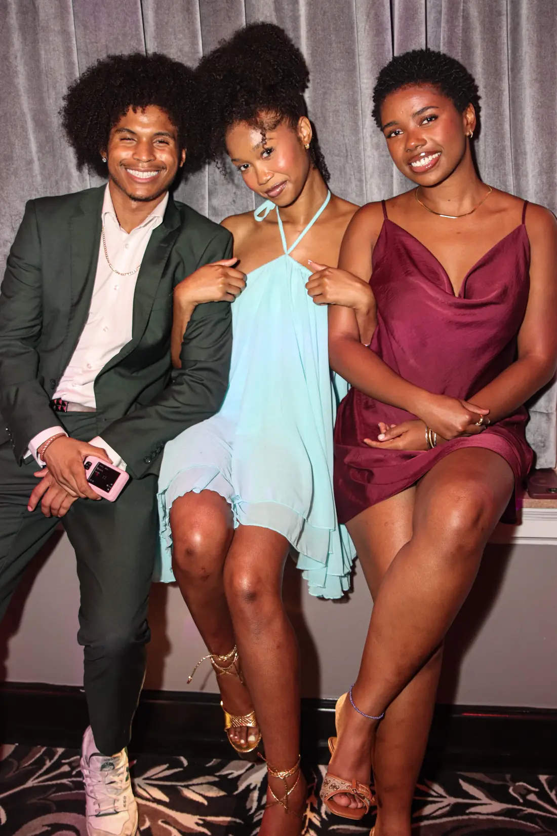 Three friends posing together at the show